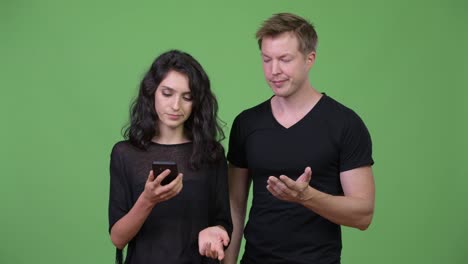 Young-couple-using-phone-together