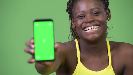 Young-African-woman-showing-phone