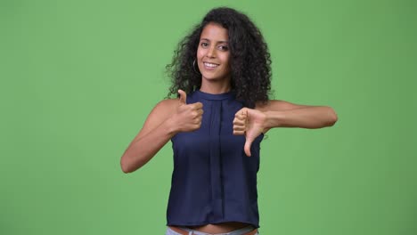 Young-beautiful-Hispanic-businesswoman-choosing-between-thumbs-up-and-thumbs-down