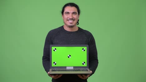 Happy-handsome-man-showing-laptop