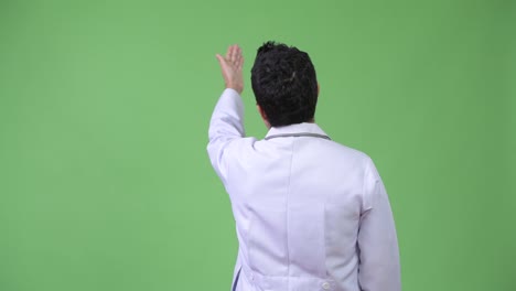 Rear-view-of-Hispanic-man-doctor-pointing-finger