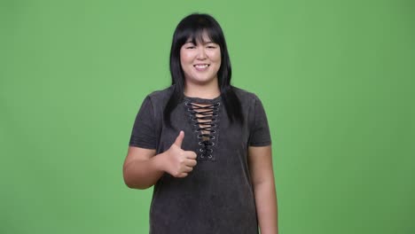 Happy-overweight-Asian-woman-giving-thumbs-up