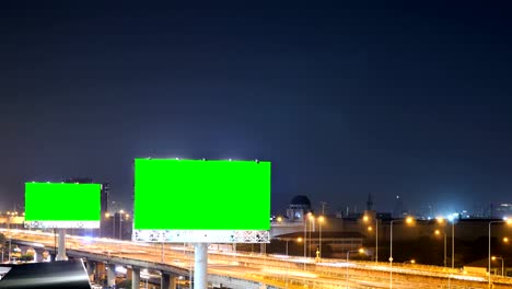 Green-screen-of-advertising-billboard-on-expressway-during-the-twilight-with-city-background-in-Bangkok,-Thailand.