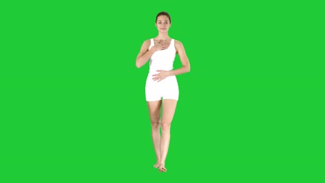 Yoga-teacher-walking-and-doing-breathing-exercise-on-a-Green-Screen,-Chroma-Key