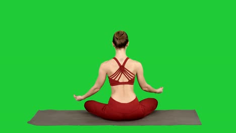 Woman-taking-a-Lotus-pose-on-a-Green-Screen,-Chroma-Key