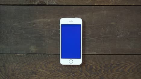 Swipes-Left-Hand-Smartphone-with-Blue-Screen