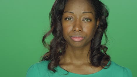 Beautiful-African-American-woman-looking-sad,-on-a-green-screen-studio-background