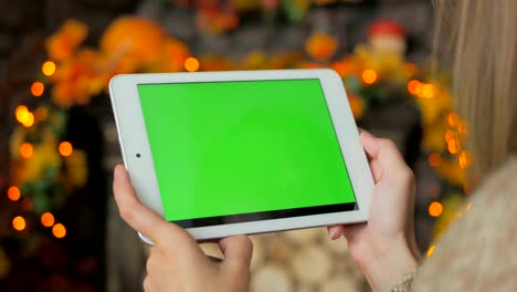 Woman-looking-at-tablet-computer-with-green-screen