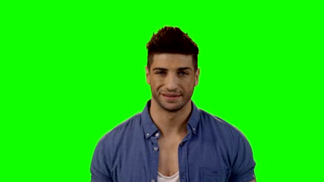 Smiling-man-standing-against-green-screen