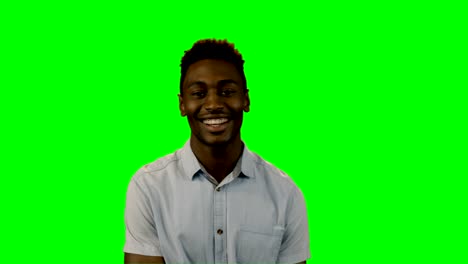 Smiling-man-standing-against-green-screen