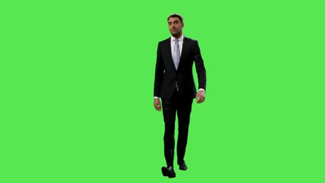 Businessman-in-a-suit-is-walking-on-a-mock-up-green-screen-in-the-background.