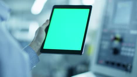 Worker-is-Using-Tablet-PC-with-Green-Screen-in-Portrait-Mode