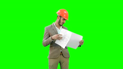 Architect-in-helmet-checking-construction-plan-on-a-Green-Screen,-Chroma-Key