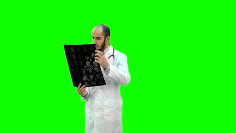 Doctor-examining-Xray-results-on-a-Green-Screen,-Chroma-Key