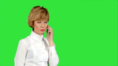 Happy-businesswoman-speaking-at-the-phone-on-a-Green-Screen,-Chroma-Key