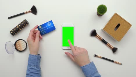 Top-View-Overhead-Of-Woman-Using-Credit-Card-And-Smartphone