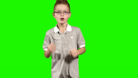 Little-boy-runs-at-green-background