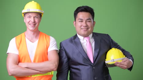 Scandinavian-man-construction-worker-and-Asian-businessman-working-together