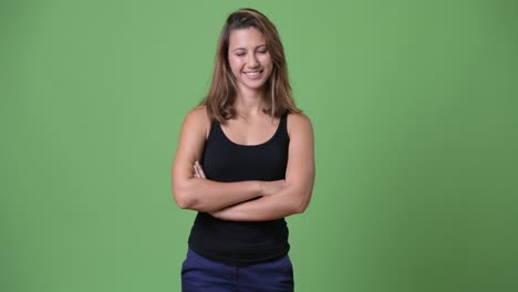 Young-beautiful-multi-ethnic-woman-against-green-background