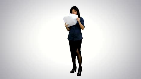 Young-business-woman-holding-documents,-reading-papers-on-white-background