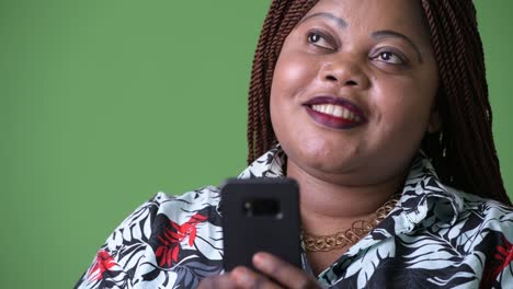 Overweight-beautiful-African-woman-against-green-background