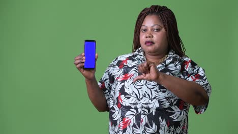 Overweight-beautiful-African-woman-against-green-background