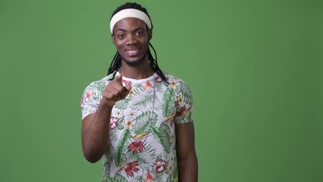 Young-handsome-African-man-with-dreadlocks-against-green-background