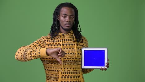 Young-handsome-African-man-with-dreadlocks-against-green-background