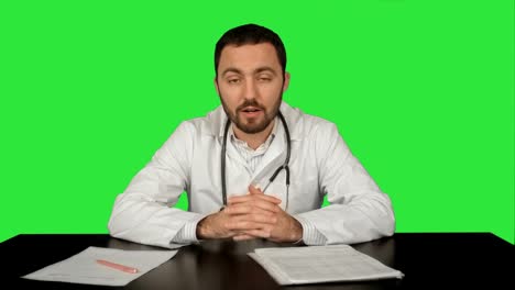 Cheerful-smiling-doctor-with-good-news-looking-at-camera-on-a-Green-Screen,-Chroma-Key