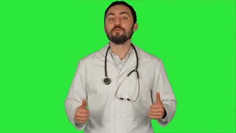 Smiling-doctor-gesturing-thumbs-up-to-camera-on-a-Green-Screen,-Chroma-Key