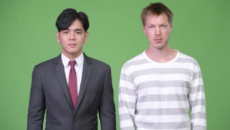 Young-handsome-Asian-businessman-and-young-Scandinavian-businessman-working-together