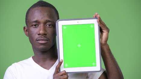 Young-African-man-showing-digital-tablet