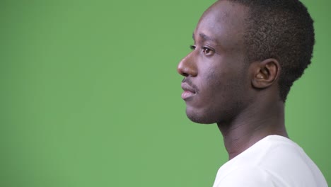 Rear-view-of-young-African-man-against-green-background