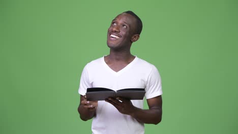 Young-African-man-reading-book-and-thinking