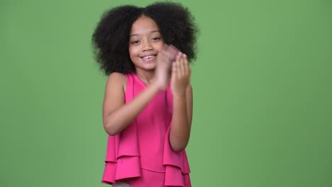 Young-happy-African-girl-with-Afro-hair-clapping-hands