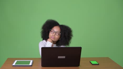 Young-cute-African-girl-with-Afro-hair-using-laptop