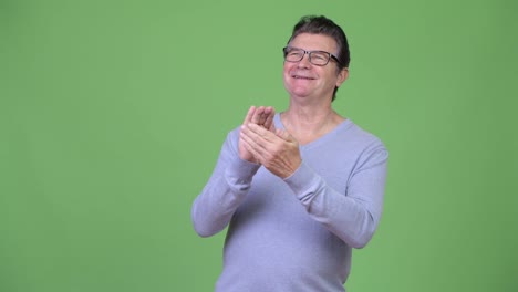 Senior-handsome-man-thinking-while-clapping-hands