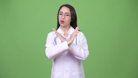 Young-beautiful-Asian-woman-doctor-with-stop-gesture