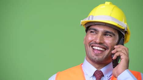 Young-handsome-Persian-man-construction-worker-talking-on-the-phone