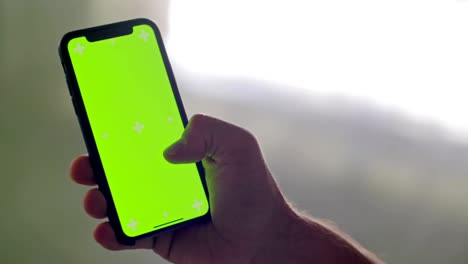 Young-adult-man-using-smartphone-with-green-screen-during-fitness-sport-workout-.Grunge-industrial-urban-training.4k-slow-motion-video