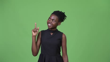 Young-beautiful-African-businesswoman-thinking-while-pointing-finger-up