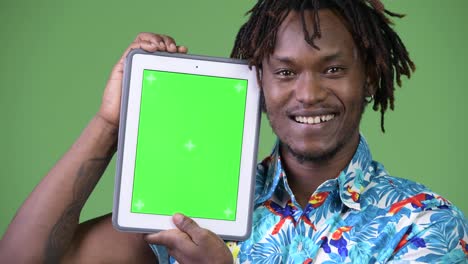 Young-handsome-African-tourist-man-showing-digital-tablet