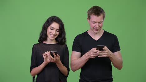 Young-couple-using-phone-together