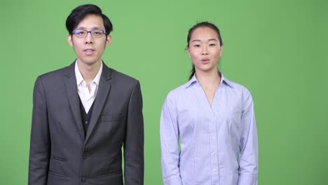 Young-Asian-business-couple-talking-together