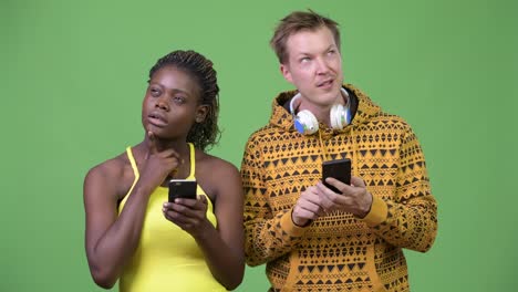 Young-multi-ethnic-couple-using-phone-together