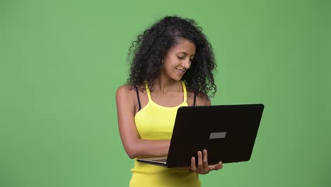 Young-beautiful-Hispanic-woman-thinking-while-using-laptop