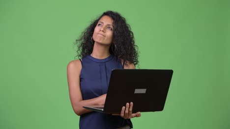 Young-beautiful-Hispanic-businesswoman-using-laptop