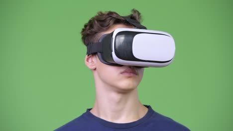 Young-handsome-teenage-boy-using-virtual-reality-headset