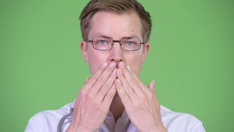 Portrait-Of-Young-Man-Doctor-Covering-Mouth