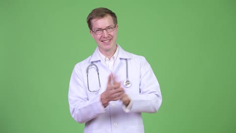 Portrait-Of-Young-Man-Doctor-Making-Applause